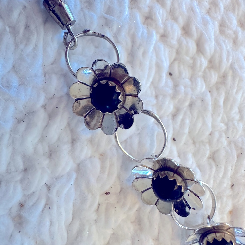 Delicate sterling silver flower bracelet with onyx stones.